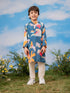 Child wearing a colorful floral kurta with a blue background