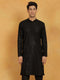 A man wearing a black cotton blend kurta with embroidered and sequined details, featuring a mandarin collar, long sleeves, and button closure. The kurta has a straight hem and side slits.